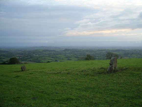 two ancient stones nestling in a field high up on the Mendips looking over the Levels