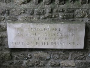 white memorial with Roman lettering: Sgt Sidney Carpenter of 301 Field Regiment Royal Artillery, died 12-2-44 in the Indian Ocean.