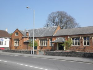 A late Victorian community building, with terracotta-coloured brickwork and an awning over the entrance.