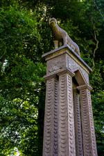 four columned tall statue with Romulus and Remus suckling on their 'mother' boar